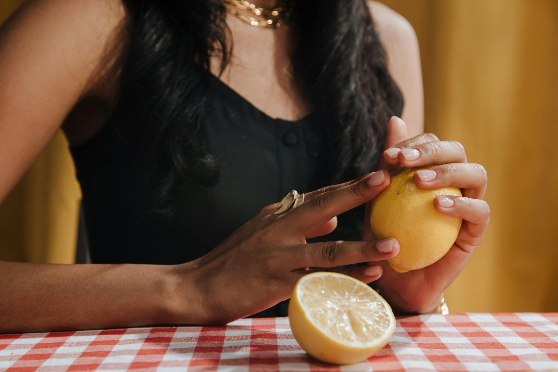 A hand holding a vibrator against a minimalistic purple backdrop, showcasing modern sensuality