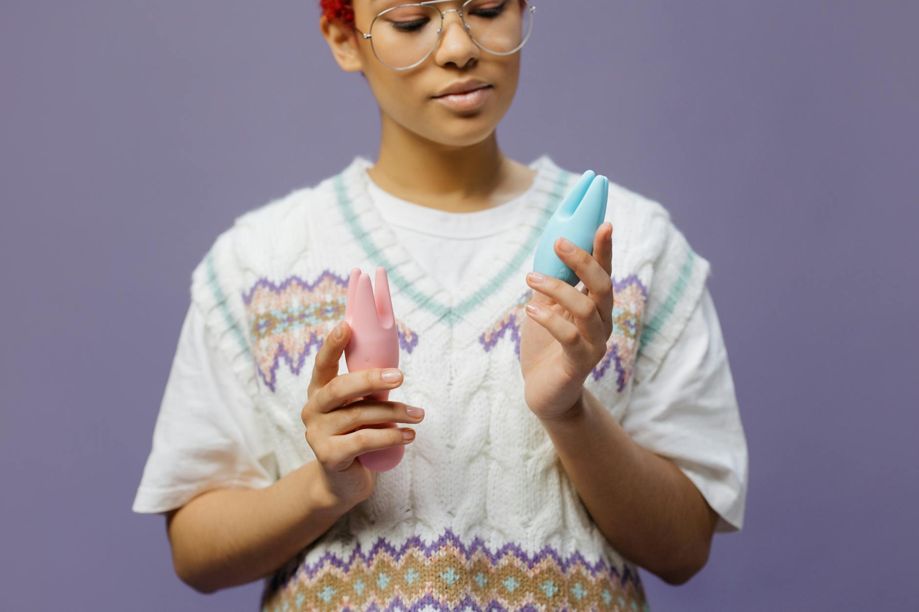 Woman holding a blue silicone vibrator, exploring personal pleasure with intention and care
